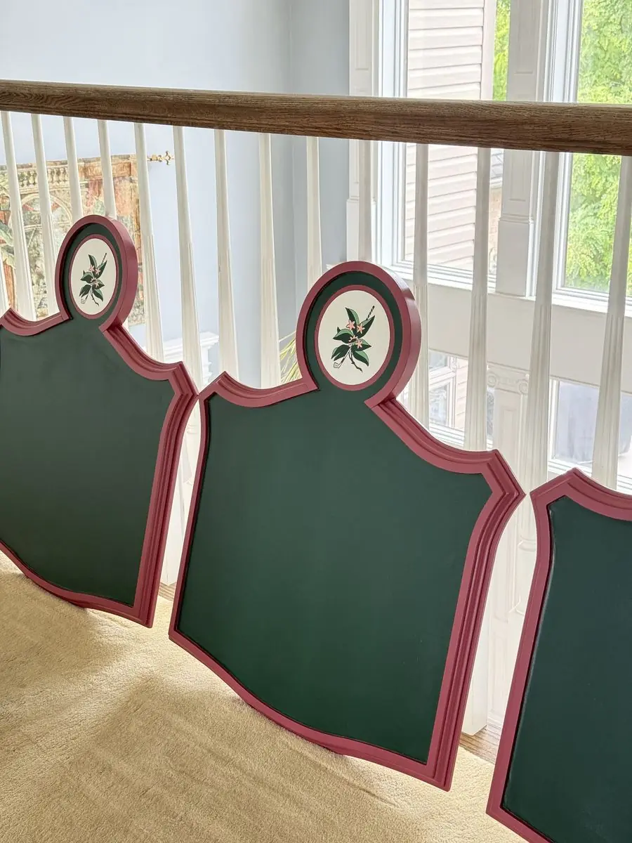 Row of green shield-shaped panels with pink borders and a round golf-and-blossom emblem at the top
